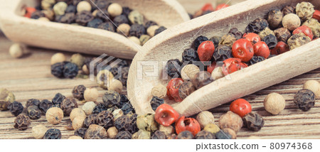 Colored pepper on wooden board. Spice using for cooking Colored pepper on wooden board. Spice using for cooking 80974368