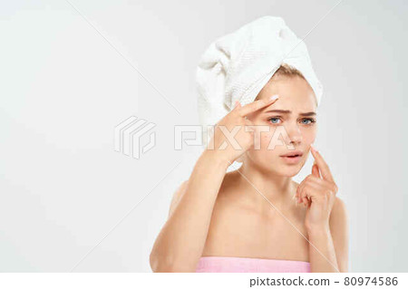 woman with towel on head health clean skin point on face 80974586