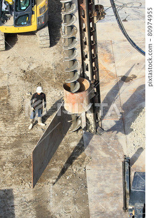 Dismantling work site Workers and augers during piling work Dismantling work site Workers and augers during piling work 80974955