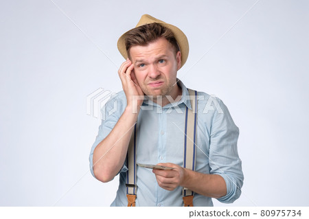 Young businessman holding and counts money dollar bills in hands Young businessman holding and counts money dollar bills in hands 80975734