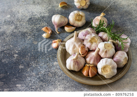 Healthy food. Garlic Cloves and Bulb on a stone or slate table. Copy space. 80976258