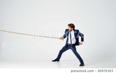 business man in suit pulling rope Studio team work business man in suit pulling rope Studio team work 80976363