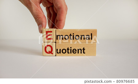 Wooden cubes and blocks with words 'EQ - emotional quotient'. Male hand. Psychological concept. Copy space, beautiful white background. 80976685