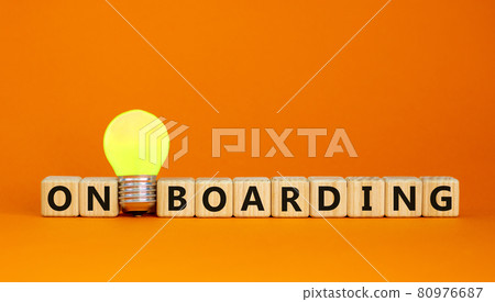 Wooden cubes with word 'onboarding'. Yellow light bulb. Beautiful orange background. Business concept. Copy space. 80976687