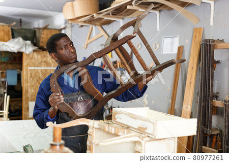 Professional restorer renewing vintage armchair 80977261