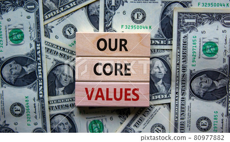 Our core values symbol. Concept words 'Our core values' on wooden blocks on a beautiful background from dollar bills. Business and our core values concept. Copy space. 80977882