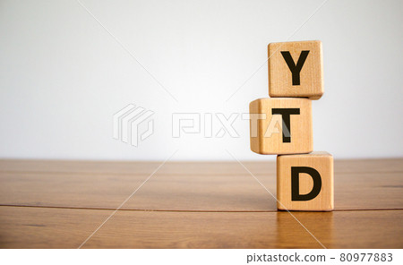 YTD symbol. Word 'YTD - year-to-date' on cubes on a beautiful wooden table, white background. Business and YTD concept. 80977883