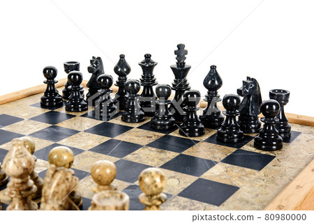 stone chess pieces on beige and black coral marble chessboard 80980000