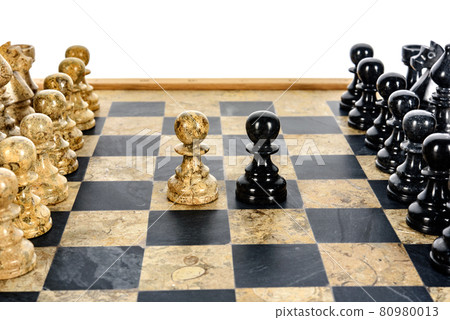 stone chess pieces on beige and black coral marble chessboard stone chess pieces on beige and black coral marble chessboard 80980013