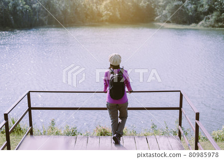 Backpacking women standing and looking beautiful view at nature,Back view 80985978