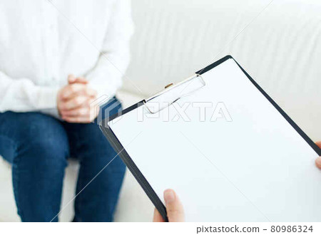 psychologist writing on paper patient communication therapy 80986324