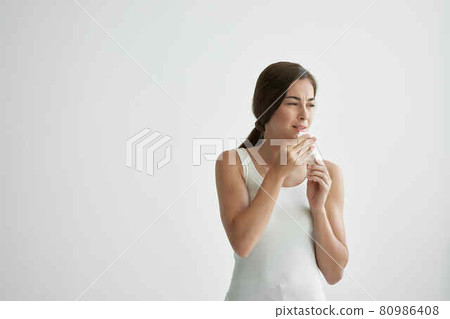 woman wiping her face with a handkerchief fire health problems flu woman wiping her face with a handkerchief fire health problems flu 80986408