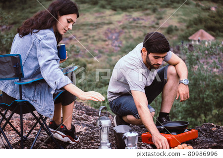 Couple lover cooking food for dinner outside tent together,Enjoying camping concept Couple lover cooking food for dinner outside tent together,Enjoying camping concept 80986996