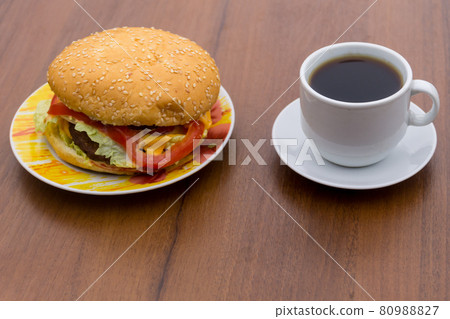 Delicious hamburger and cup of coffee on wooden table 80988827