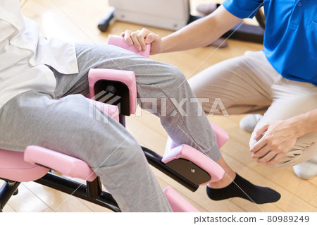 Elderly people exercising in the fitness corner of a long-term care facility Elderly people exercising in the fitness corner of a long-term care facility 80989249