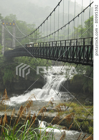 Suspension bridge and waterfall over the Keelung River, Shihfen, Taiwan 80995392