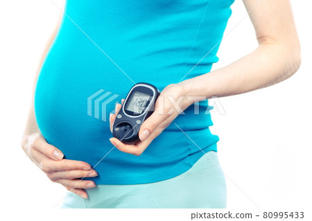 Pregnant woman holding glucose meter with result of sugar level, diabetes during pregnancy 80995433