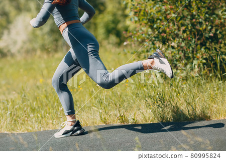Runner woman in running shoes closeup of woman sporty legs. Female jogging. 80995824