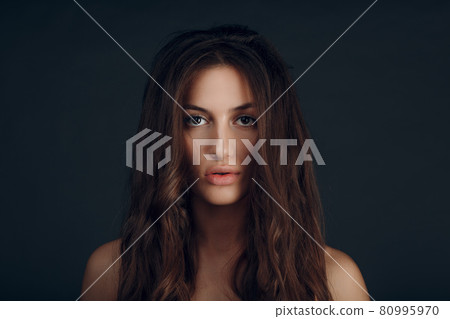 Portrait of beautiful young brunette woman with healthy hair Portrait of beautiful young brunette woman with healthy hair 80995970