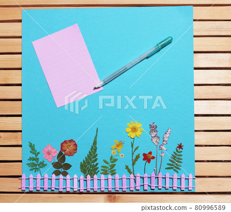 Dried Flowers On Blue Paper With pen and room for text Dried Flowers On Blue Paper With pen and room for text 80996589