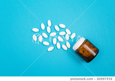 Pharmaceutical Industry and Medicinal Products - White Pills on Blue Table Pharmaceutical Industry and Medicinal Products - White Pills on Blue Table 80997458