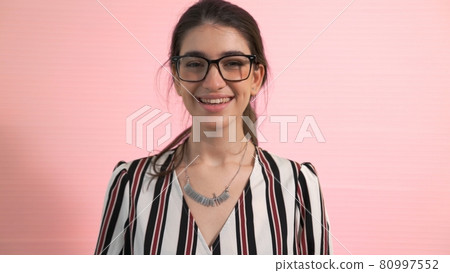 Portrait of young woman merrily pose in studio Portrait of young woman merrily pose in studio 80997552