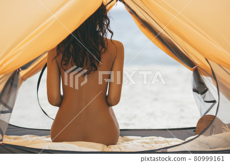Naked Woman on the Beach in a Tent 80999161