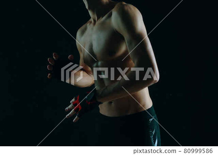 man with a pumped-up torso workout exercise sport dark background 80999586