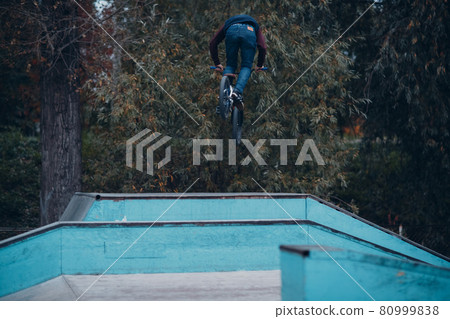 Professional young sportsman cyclist with bmx bike at skatepark. Professional young sportsman cyclist with bmx bike at skatepark. 80999838