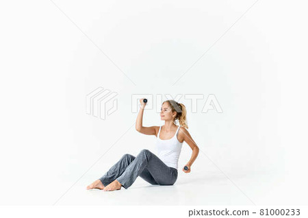 woman with green dumbbells in hands exercise workout gym fitness 81000233