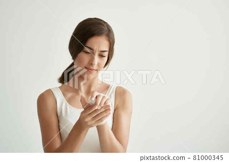 woman holding hand health problems injury close-up 81000345