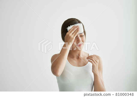 woman with headache holding headscarf on the corner migraine 81000348