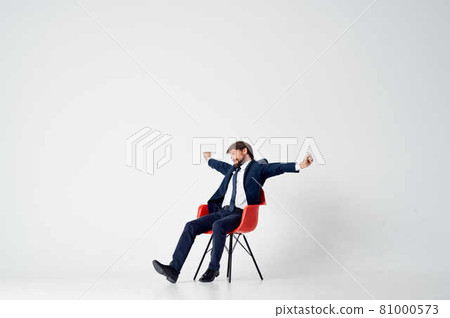 business man in suit sitting on red chairs manager office work 81000573