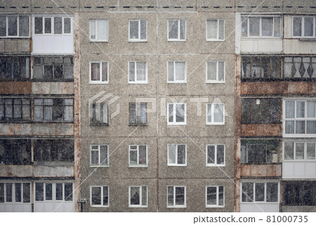 Facade of a grey multi-storey soviet panel building Facade of a grey multi-storey soviet panel building 81000735