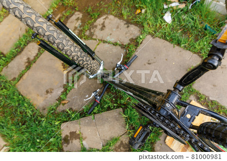 Bike waiting mechanic for repair in bicycle repair shop, outdoor. Bicycle wheel close up ready for examines, fixes modern cycle transmission system. Bike maintenance, sport shop concept. Bike waiting mechanic for repair in bicycle repair shop, outdoor. Bicycle wheel close up ready for examines, fixes modern cycle transmission system. Bike maintenance, sport shop concept. 81000981