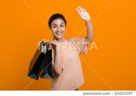 Indian woman holds shopping bags in hands. Sale and Black Friday concept. Indian woman holds shopping bags in hands. Sale and Black Friday concept. 81003597
