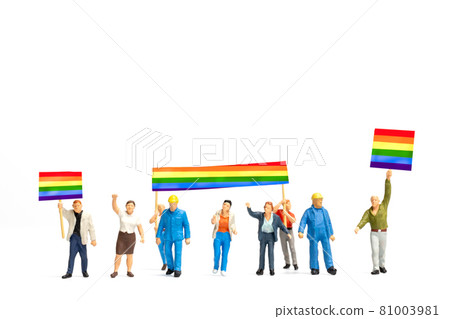 Miniature people Protester holding a transgender flag sign encouraging social distancing Miniature people Protester holding a transgender flag sign encouraging social distancing 81003981
