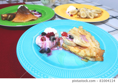 Crepes served on colorful plates Crepes served on colorful plates 81004114