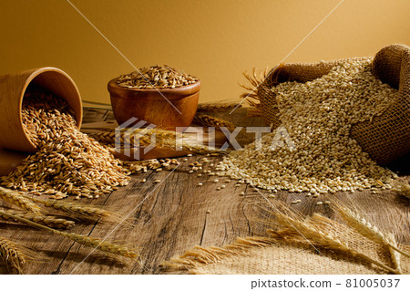 Wheat nuts bag on a wooden table 81005037