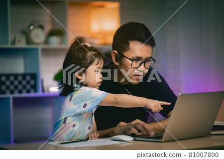 freelancer man working with laptop on the table and talking with his daughter 81007800