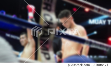 Thai Kick boxing. Blurred images of Muay Thai. Martial Art Kickboxing. Local and foriegn boxer are fighting on the ring at stadium stage. Muaythai is sport competition for traveller sightseeing. 81008571