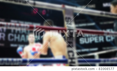 Thai Kick boxing. Blurred images of Muay Thai. Martial Art Kickboxing. Local and foriegn boxer are fighting on the ring at stadium stage. Muaythai is sport competition for traveller sightseeing. Thai Kick boxing. Blurred images of Muay Thai. Martial Art Kickboxing. Local and foriegn boxer are fighting on the ring at stadium stage. Muaythai is sport competition for traveller sightseeing. 81008577