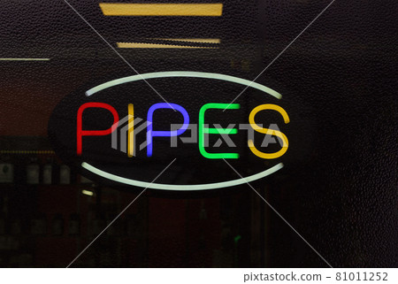 Colorful Neon Pipes Sign in Rainy Window of Smoke Shop 81011252