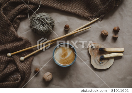 Autumn time. Cozy hygge home decor with a cup, candles, plaid Autumn time. Cozy hygge home decor with a cup, candles, plaid 81011601