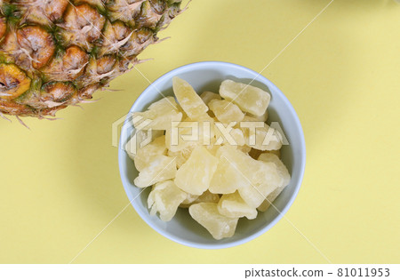 Fresh and Dried Pineapple on yellow Background Closeup Fresh and Dried Pineapple on yellow Background Closeup 81011953