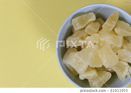 Fresh and Dried Pineapple on yellow Background Closeup Fresh and Dried Pineapple on yellow Background Closeup 81011955