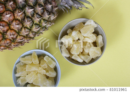 Fresh and Dried Pineapple on yellow Background Closeup Fresh and Dried Pineapple on yellow Background Closeup 81011961