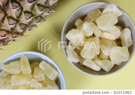 Fresh and Dried Pineapple on yellow Background Closeup Fresh and Dried Pineapple on yellow Background Closeup 81011962