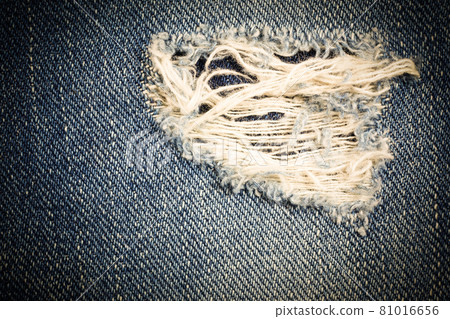 Vintage jeans torn denim texture. Vintage jeans torn denim texture. 81016656
