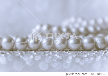 Nature white pearl beads on sparkling background Nature white pearl beads on sparkling background 81018432